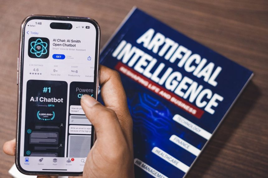 Smartphone exibindo um aplicativo de inteligência artificial, com um livro sobre tecnologia de IA ao fundo.